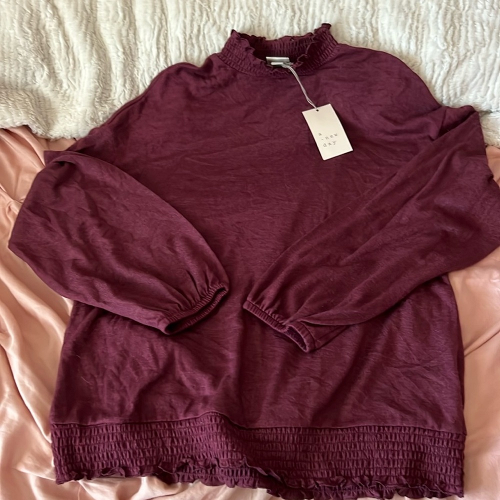 Purple long sleeved shirt, with ruffled neck and bottom, New with tag
